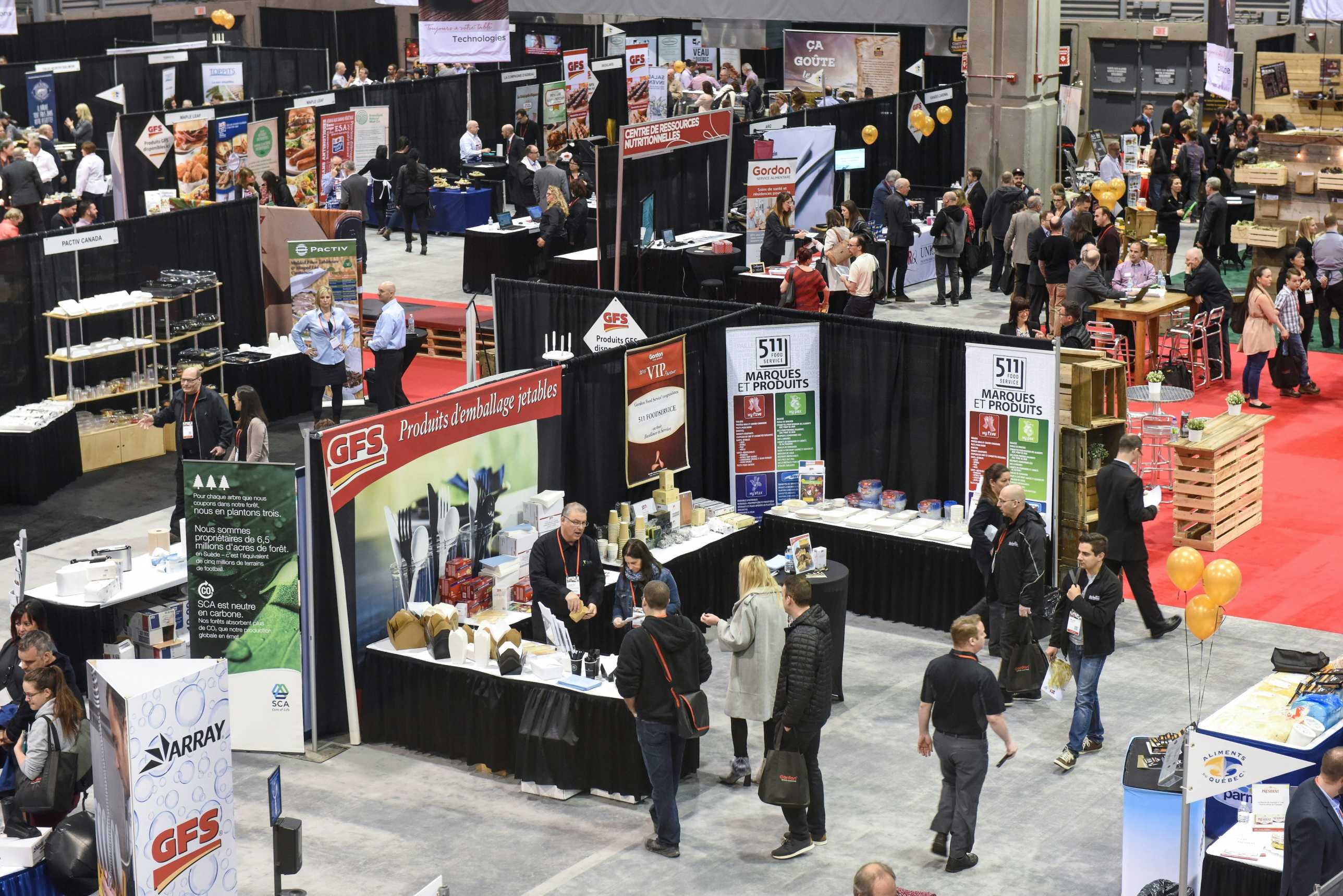 Business executives discussing partnerships at Asia FoodTech exhibition floor